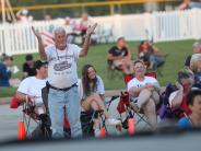 Man in crowd standing to applaud a band