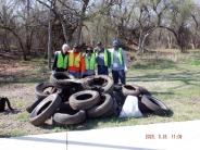 Group of volunteers from Mid-America park clean up with tires
