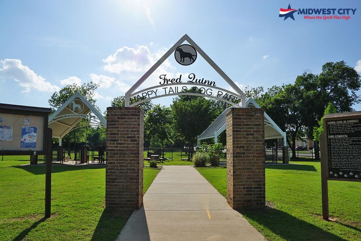 Entrance to the Dog Park- large sign reading Fred Quinn Happy Tails Dog Park